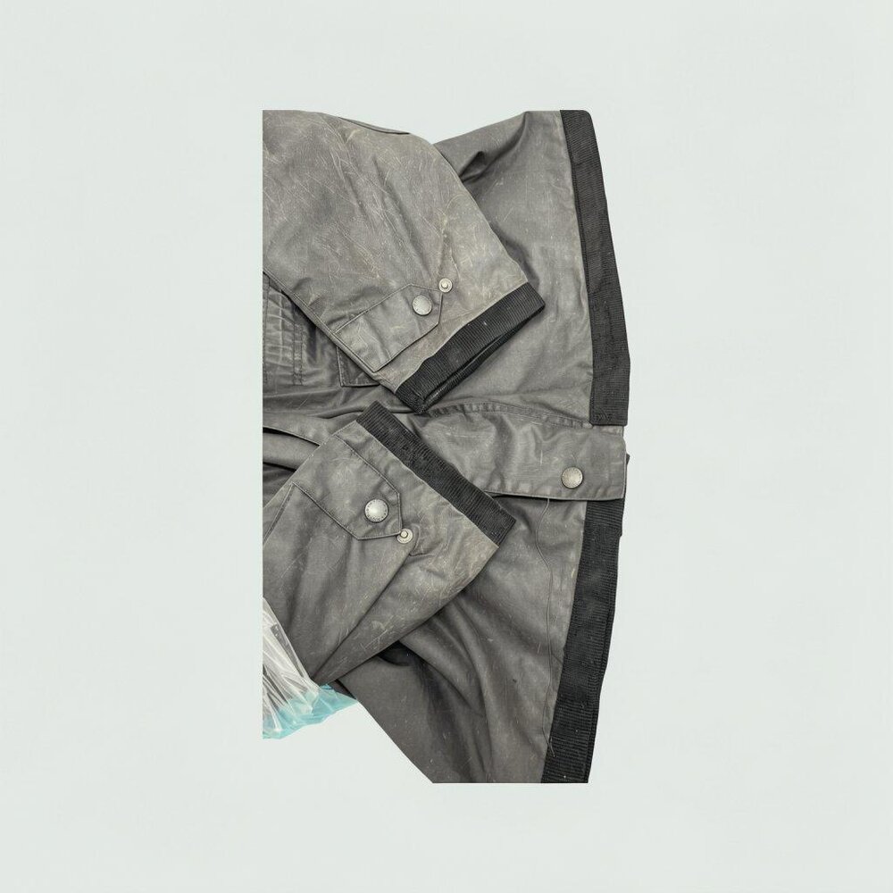 Wax jacket pocket and hem after repair, restored and clean finish